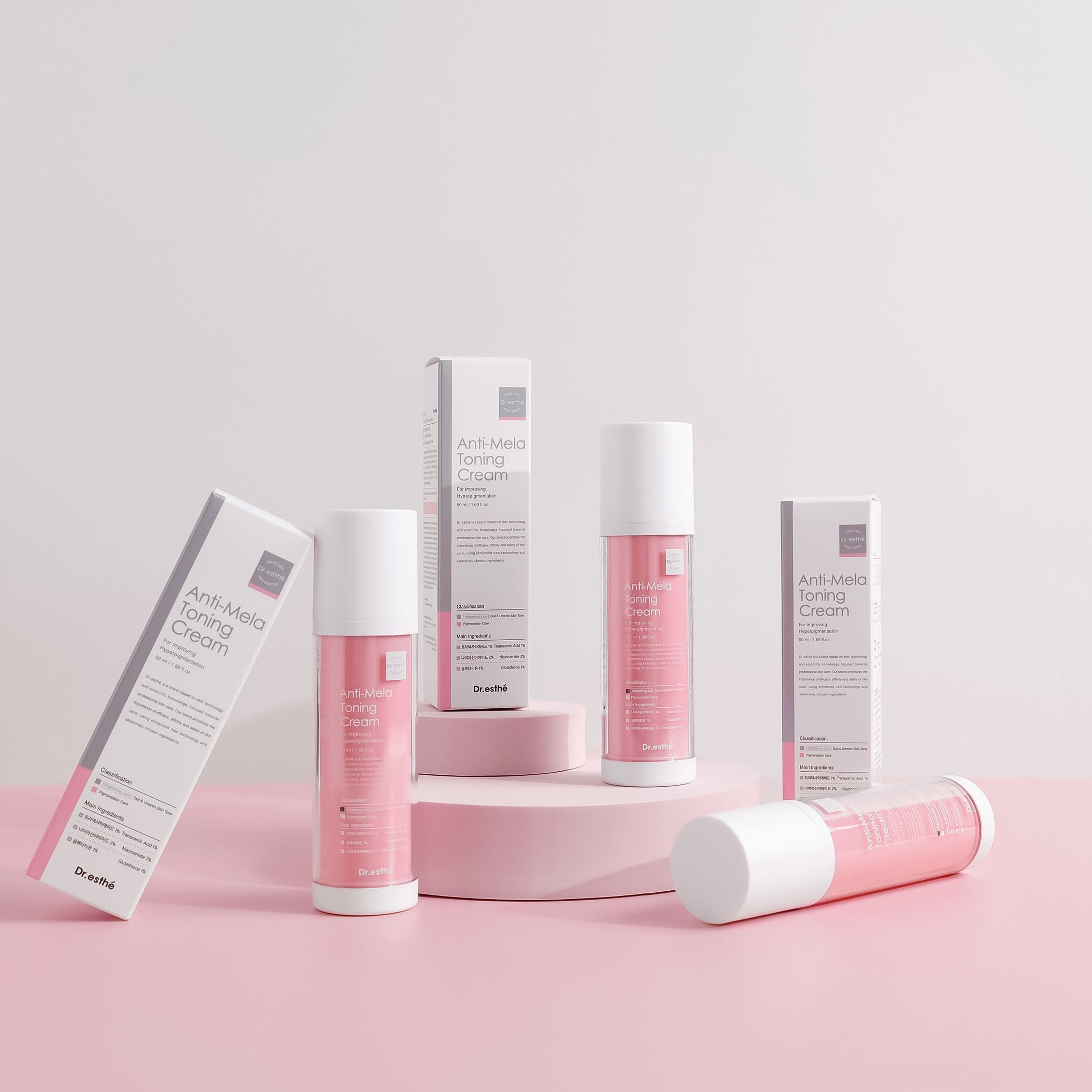 Cosmetic products with pink and white packaging on a light pink background