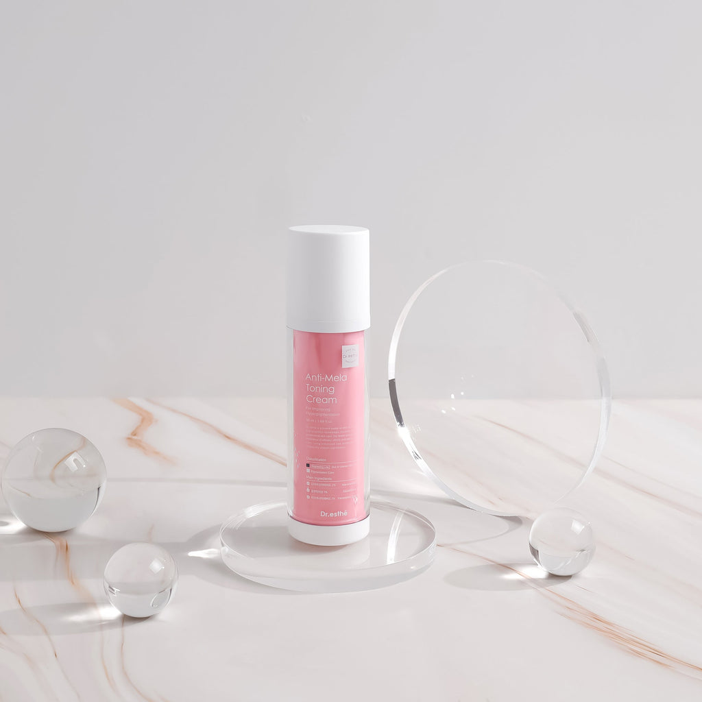 Skincare bottle with pink label on a marble surface