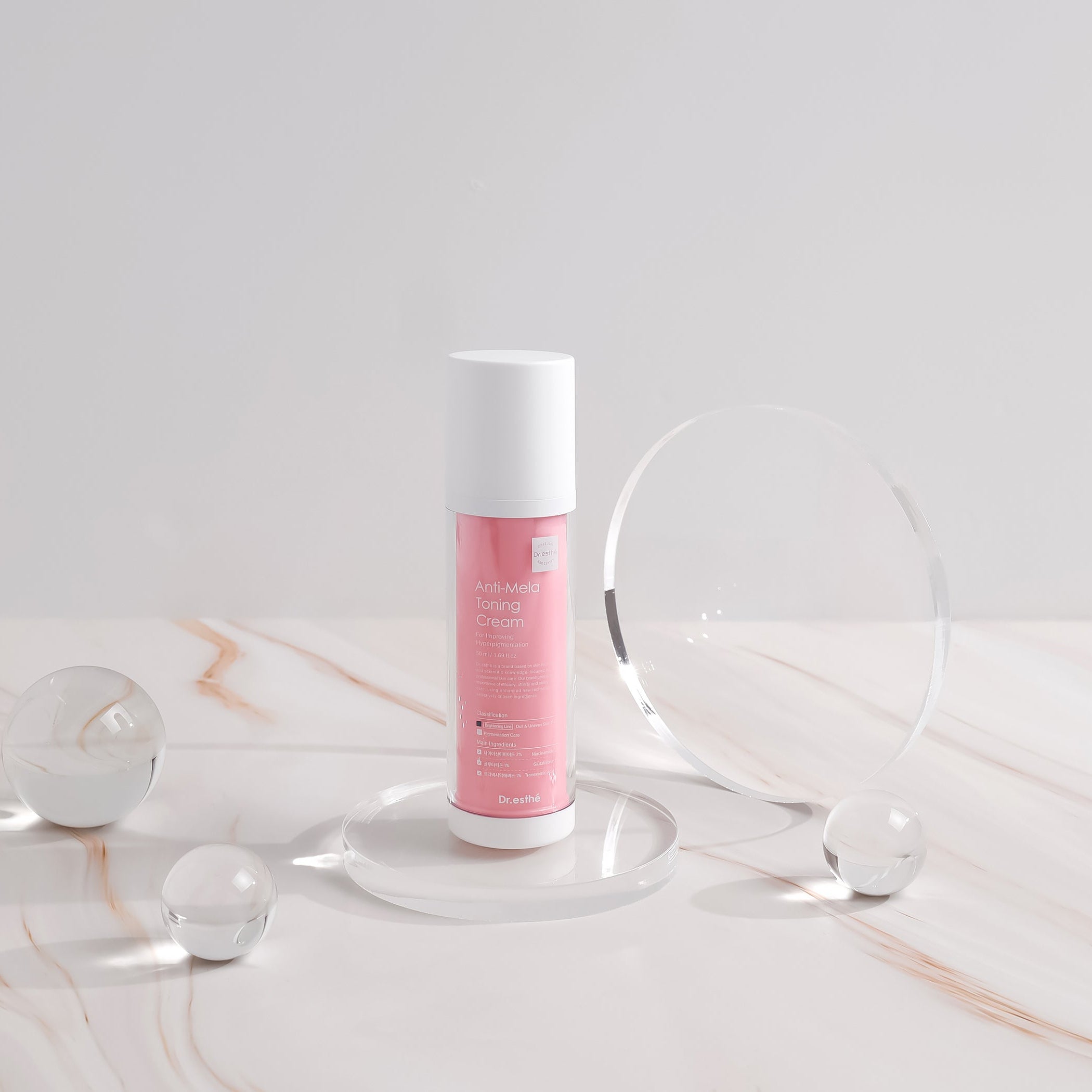 Skincare bottle with pink label on a marble surface