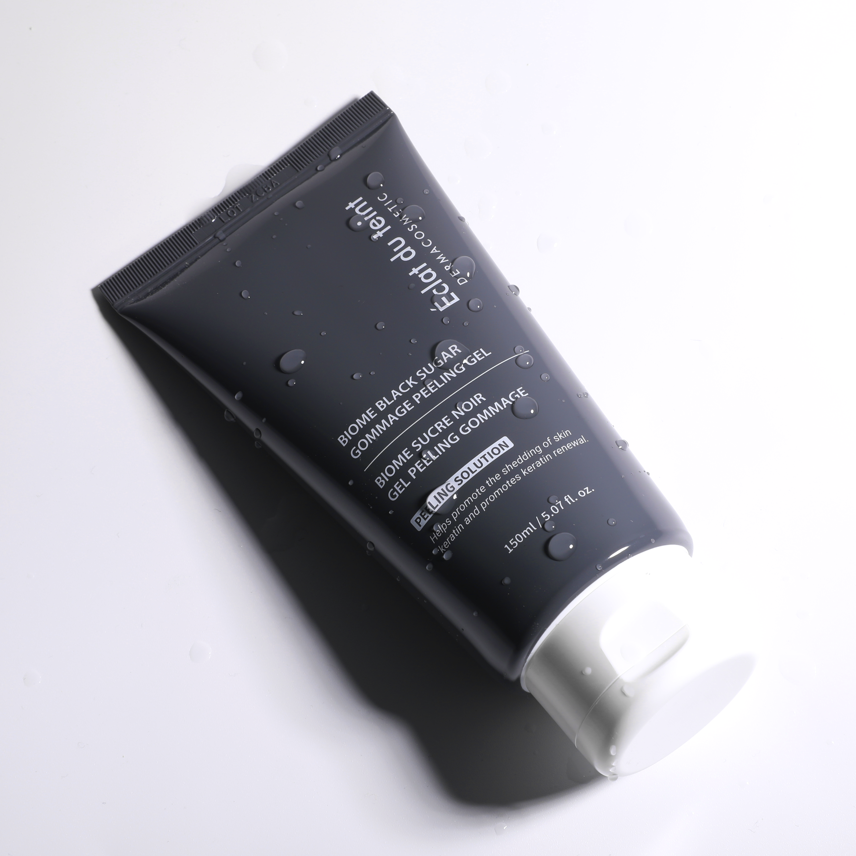Eclat du teint Black sugar gommage peeling gel skincare product tube on a white background